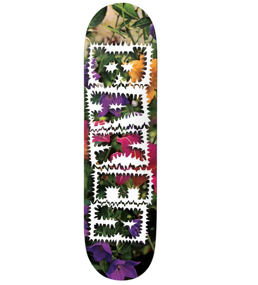 Skateboard deck with a colorful floral pattern on a white background