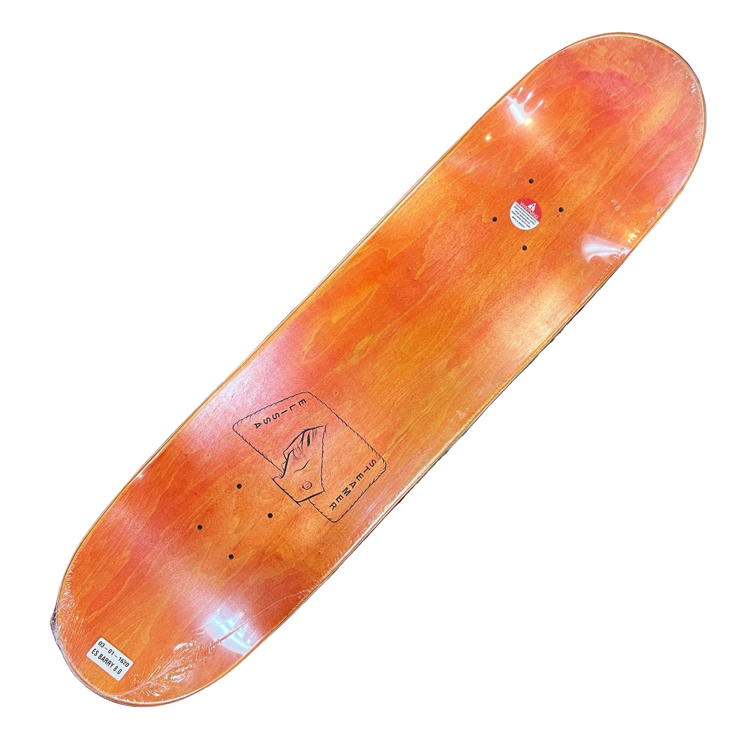 Skateboard deck on a red and beige patterned surface