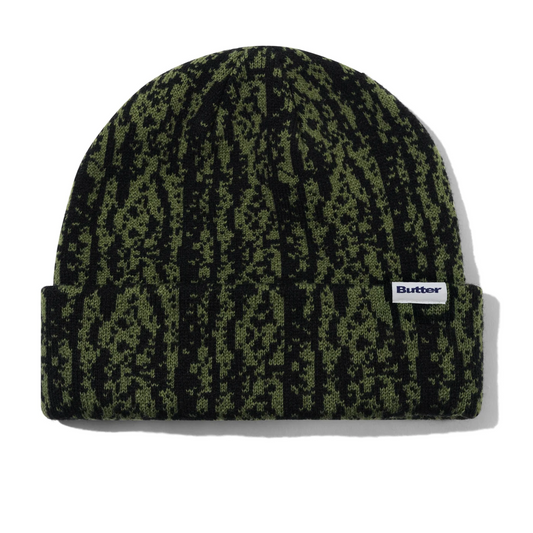 Green patterned beanie with a brand logo on a white background