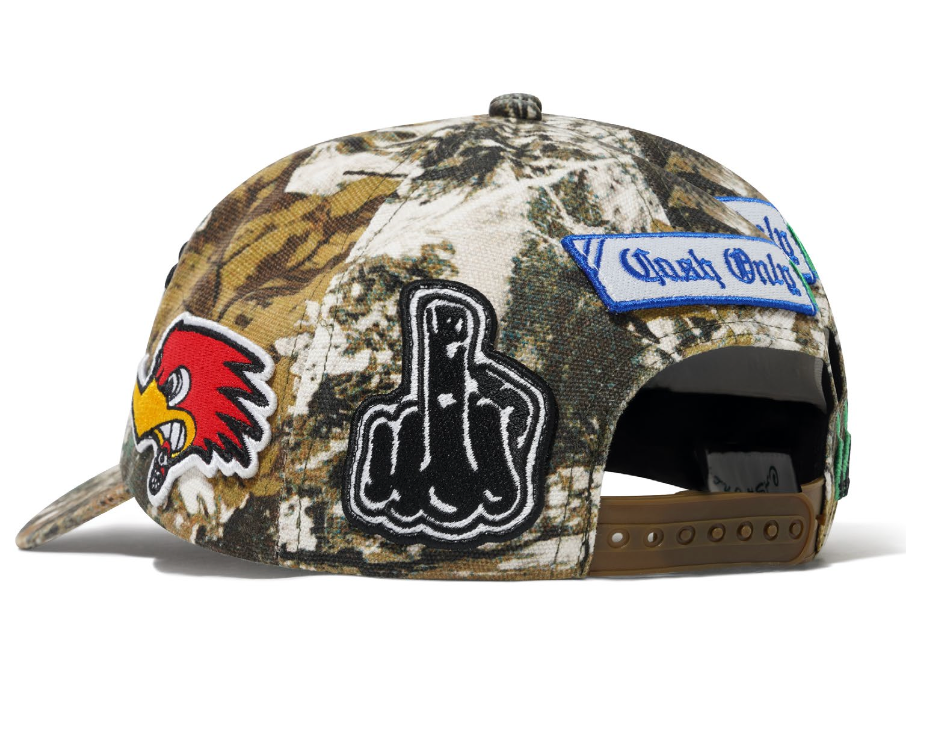 Camouflage cap with various patches on a white background