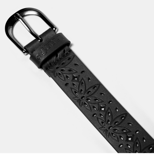 Black leather belt with floral patterns and a silver buckle on a light gray background