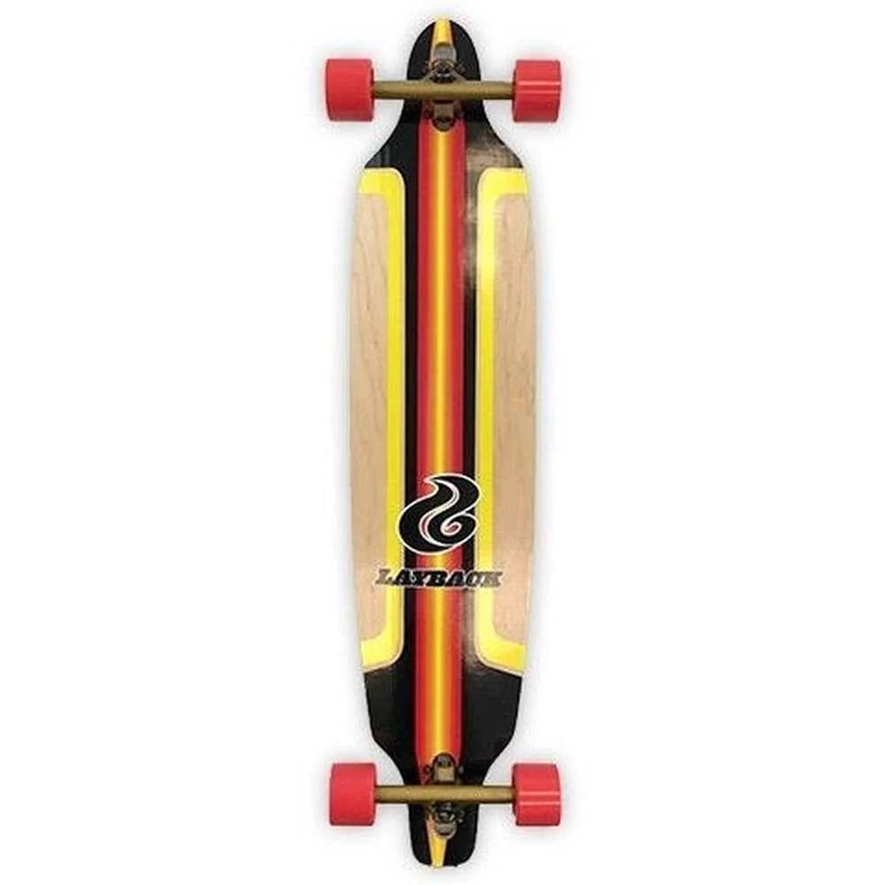 A longboard has a natural wood base with bold black, red, and yellow graphic stripes, a stylized black logo, and the word 'LAYBACK' printed near the tail.