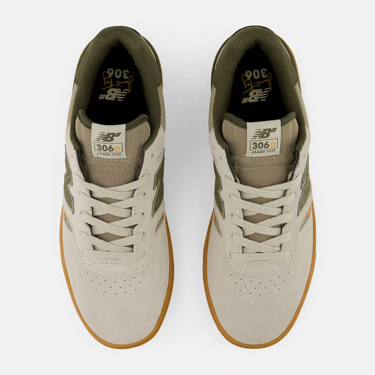 Pair of beige sneakers with brown soles on a white background