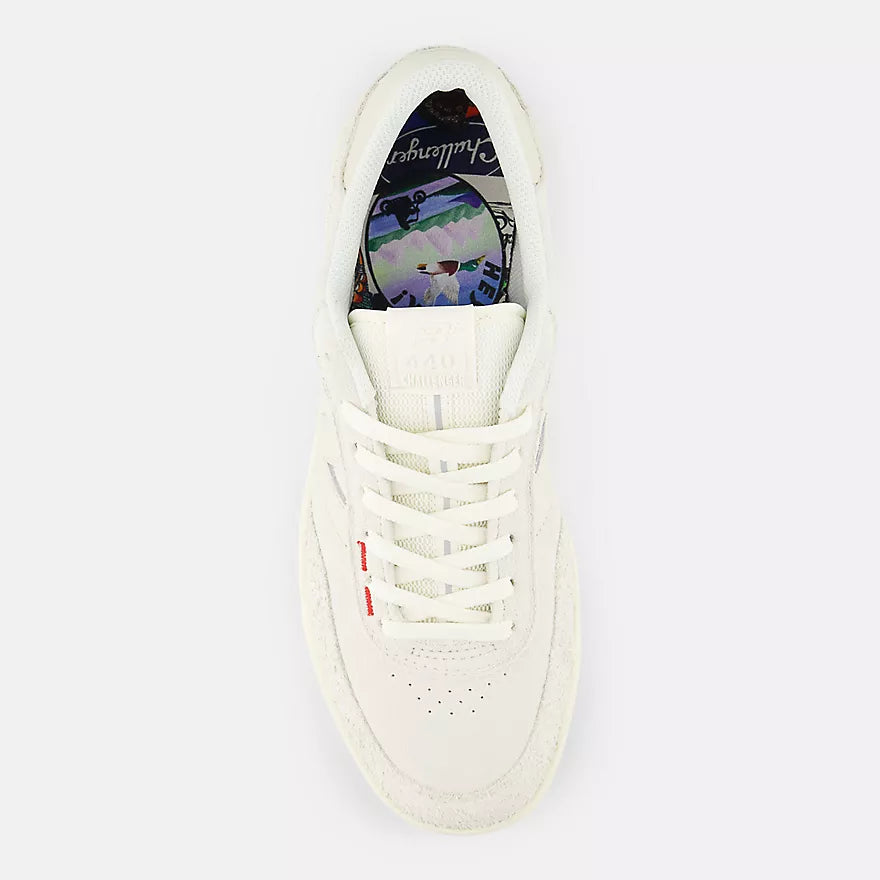 White sneaker with colorful sole on a white background