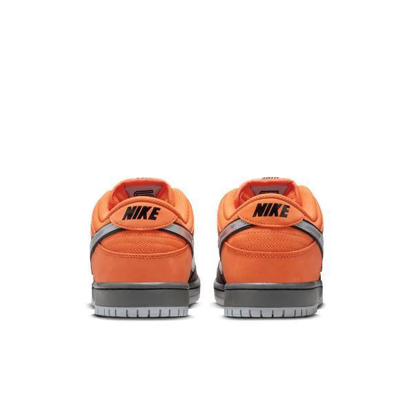 Orange Nike sneakers with black swoosh logo on a white background