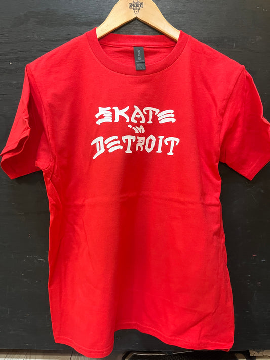 Red t-shirt with 'Skate Detroit' text on a wooden hanger against a dark background