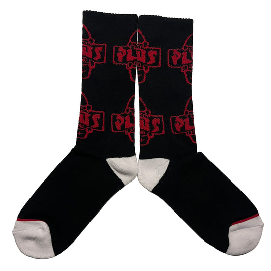 Black socks with red geometric pattern on a light gray background