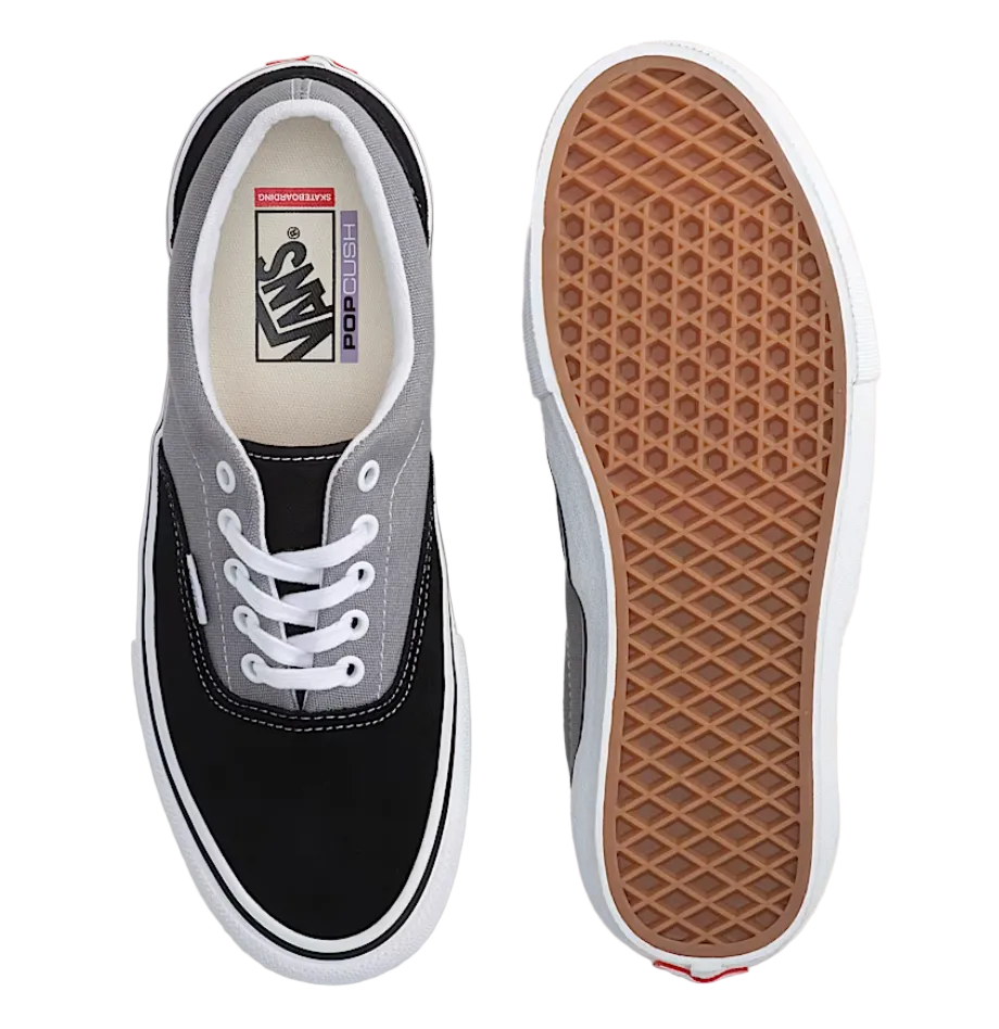 Black and gray sneaker with white laces on a light gray background