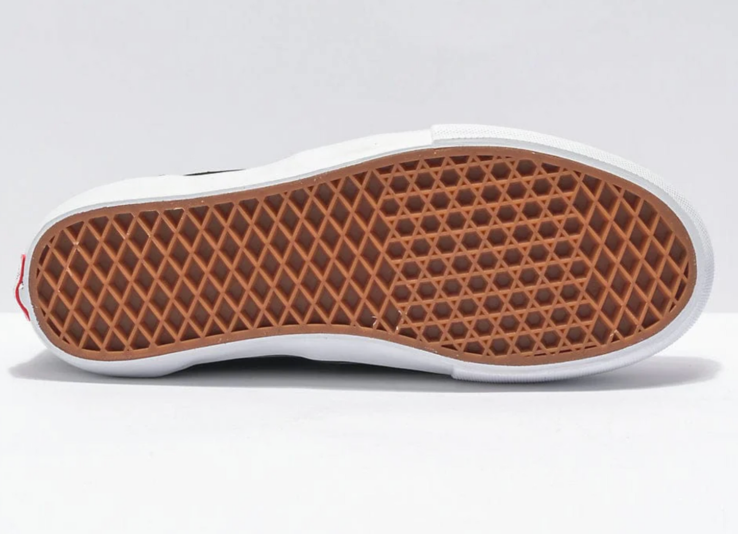 Close-up of a shoe sole with brown pattern on a white background