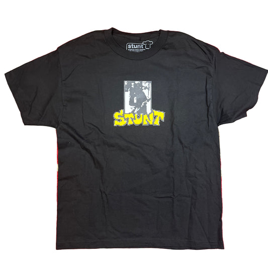 Black t-shirt with 'stunt' graphic on a red and beige background