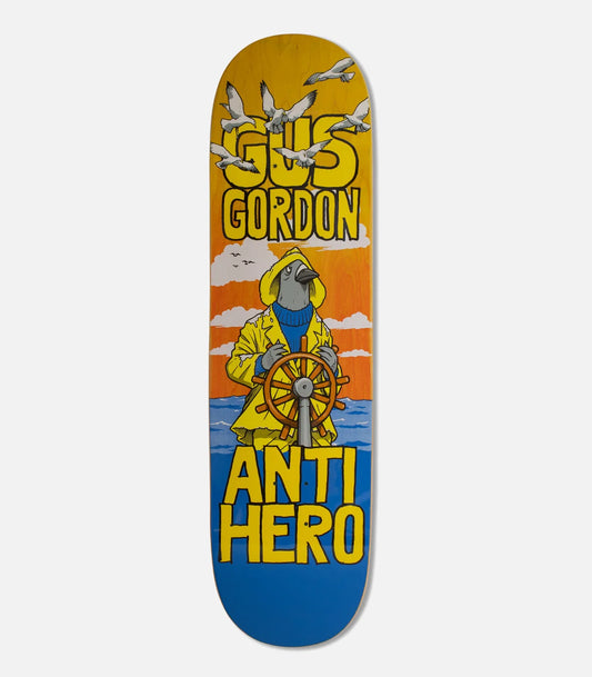 A skateboard deck featuring a colorful graphic illustration of a bird in a yellow raincoat steering a ship, with the text 'GUS GORDON' at the top and 'ANTI HERO' at the bottom