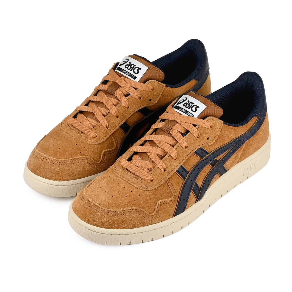 A pair of Asics low-top sneakers in tan suede with navy blue side stripes and navy lining, featuring off-white soles, shown on a plain white background.