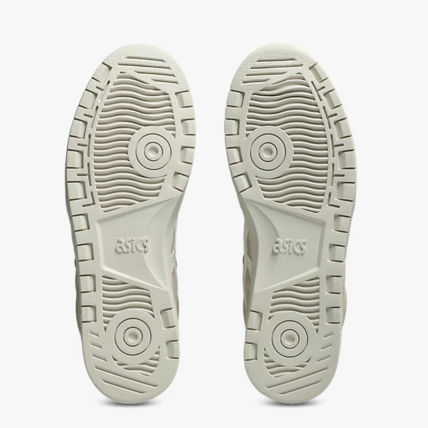 Close-up of the soles of a pair of shoes on a white background