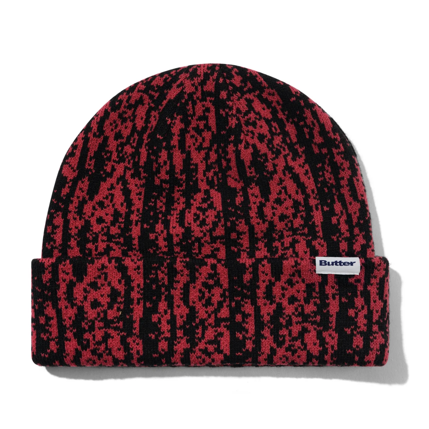 Red and black patterned beanie with a visible brand logo on a white background