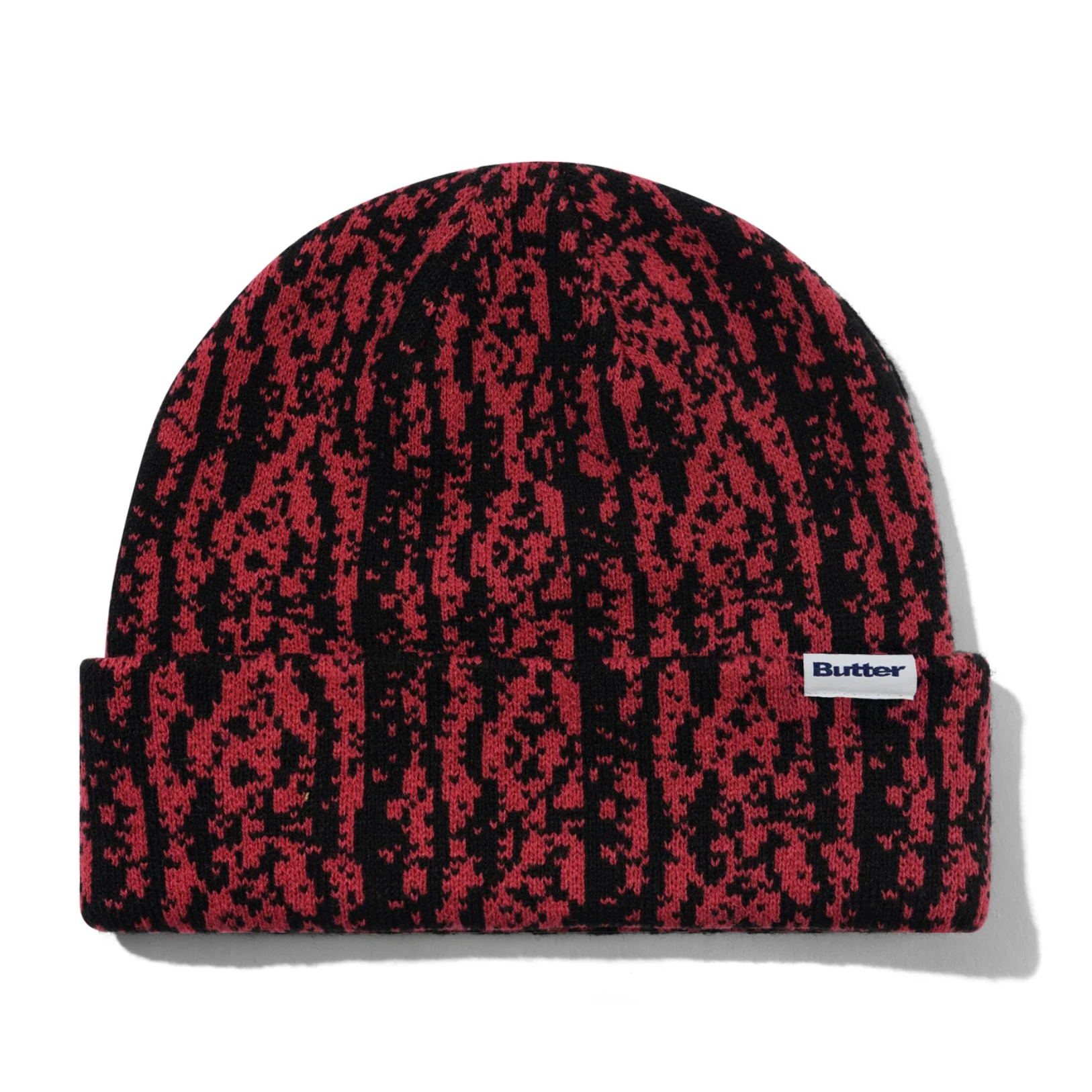 Red and black patterned beanie with a visible brand logo on a white background