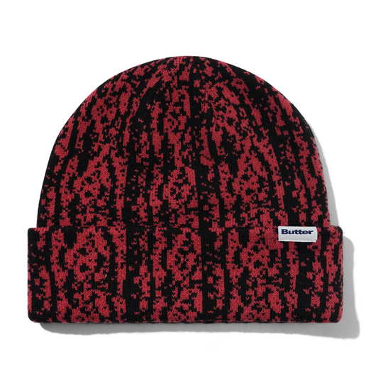 Red and black patterned beanie with a visible brand logo on a white background
