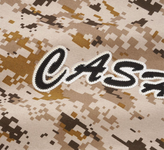 Camouflage fabric with 'CASH' logo in black and white