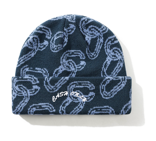 Navy blue beanie with white graphic pattern on a white background