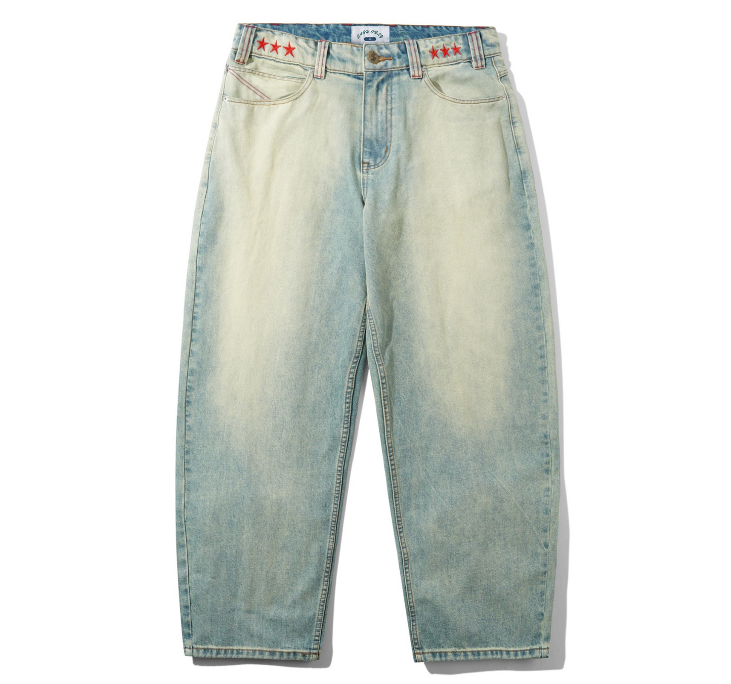 Light blue jeans with red star patches on a white background