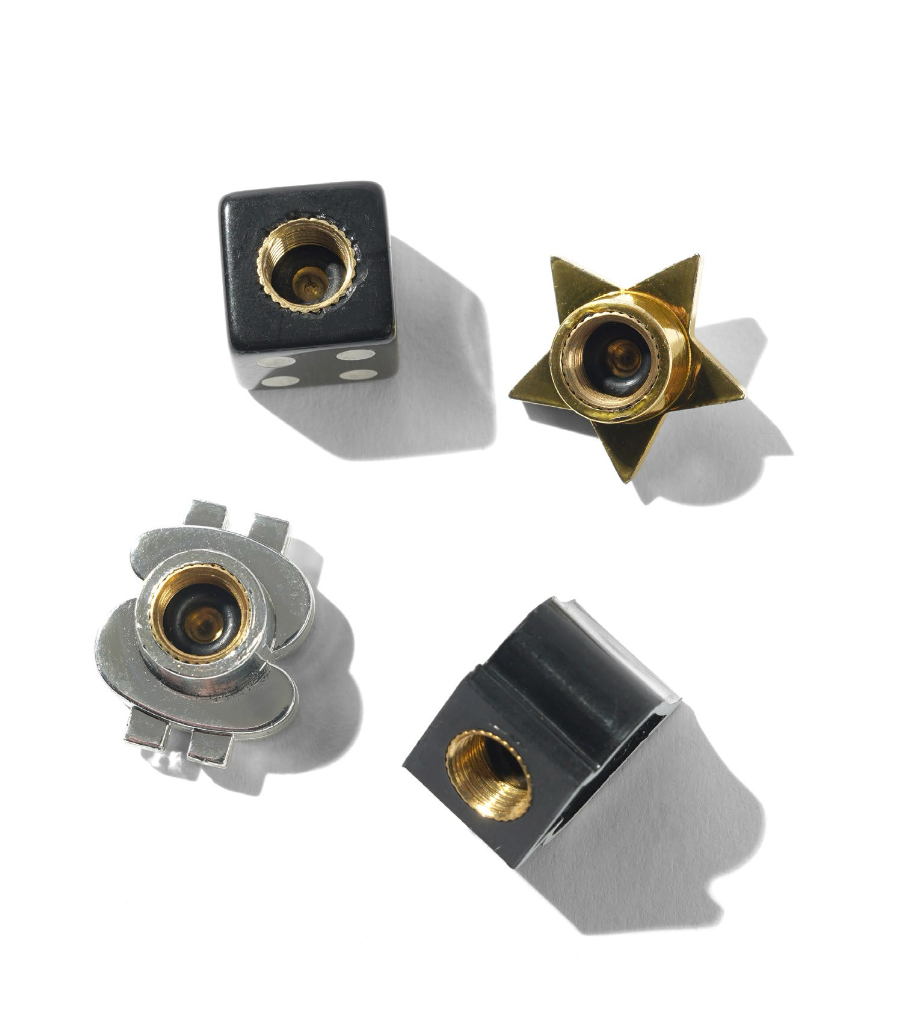 Four metal components with gold and silver finishes on a white background