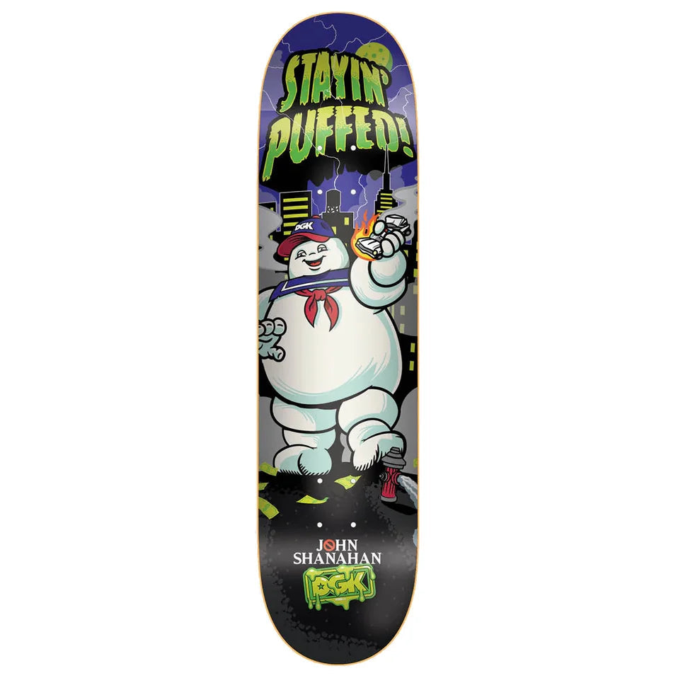 A skateboard deck featuring a Ghostbusters-themed graphic with the Stay Pufted character, the words 'STAYIN' PUFFED!', and 'JOHN SHANAHAN ROCKS' printed on a black background.