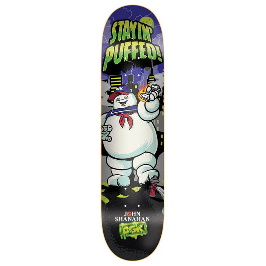 A skateboard deck featuring a Ghostbusters-themed graphic with the Stay Pufted character, the words 'STAYIN' PUFFED!', and 'JOHN SHANAHAN ROCKS' printed on a black background.