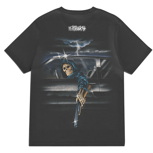 Black t-shirt with a graphic of a skeleton driving a car and holding a gun, with a brand logo on the chest.