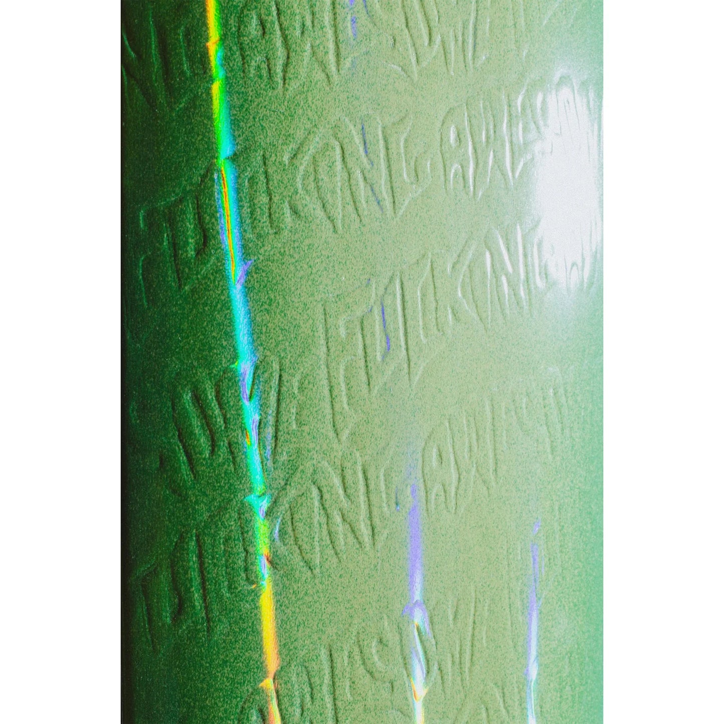 Close-up of a textured green surface with embossed text