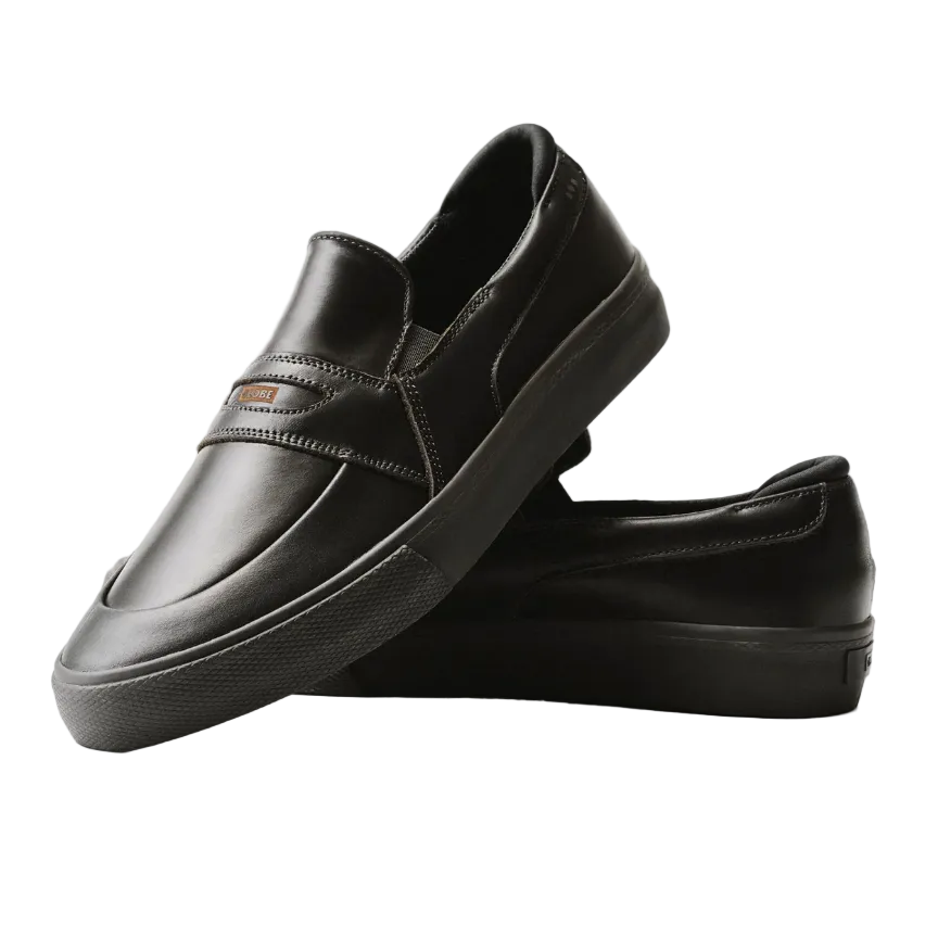 Pair of black slip ons on white background