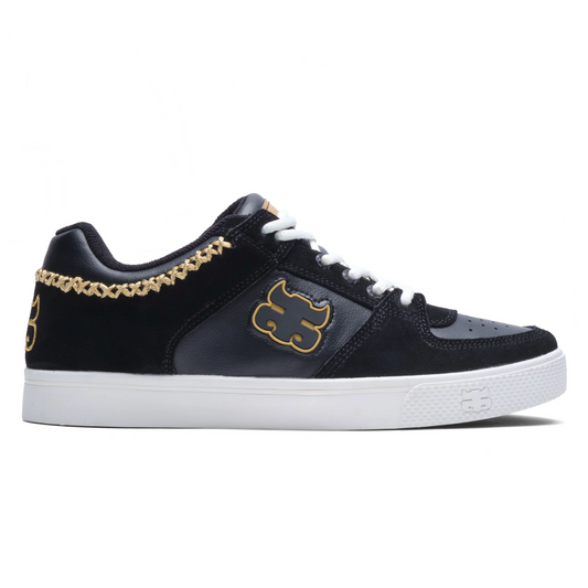Black sneaker with gold accents on a white background