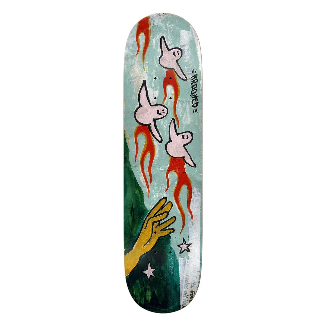 A skateboard deck featuring a surreal art design with krooked ghosts with red tails, a yellow hand reaching up, and white stars on a textured light blue and green background.
