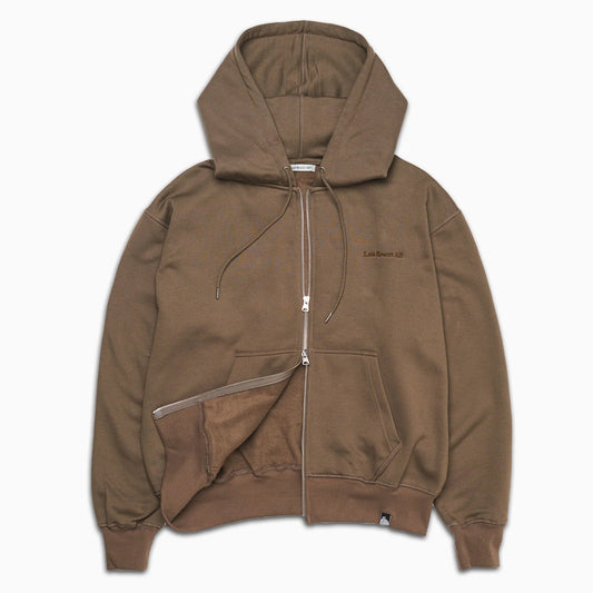 A brown zip-up hoodie with a drawstring hood, kangaroo pockets, and a small embroidered logo on the left chest, displayed against a plain white background.