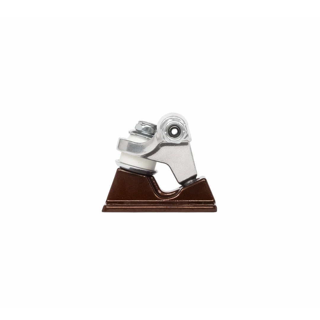 A close-up of a skateboard truck component with a brown base plate and silver metal hardware