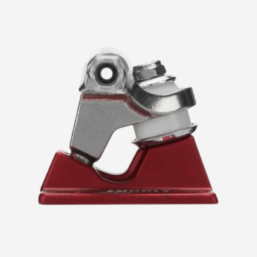 A close-up of a skateboard truck component with a red base plate and silver metal hardware