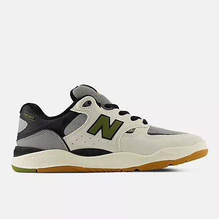 A New Balance sneaker in off-white, black, and olive green, shown from a side profile view.