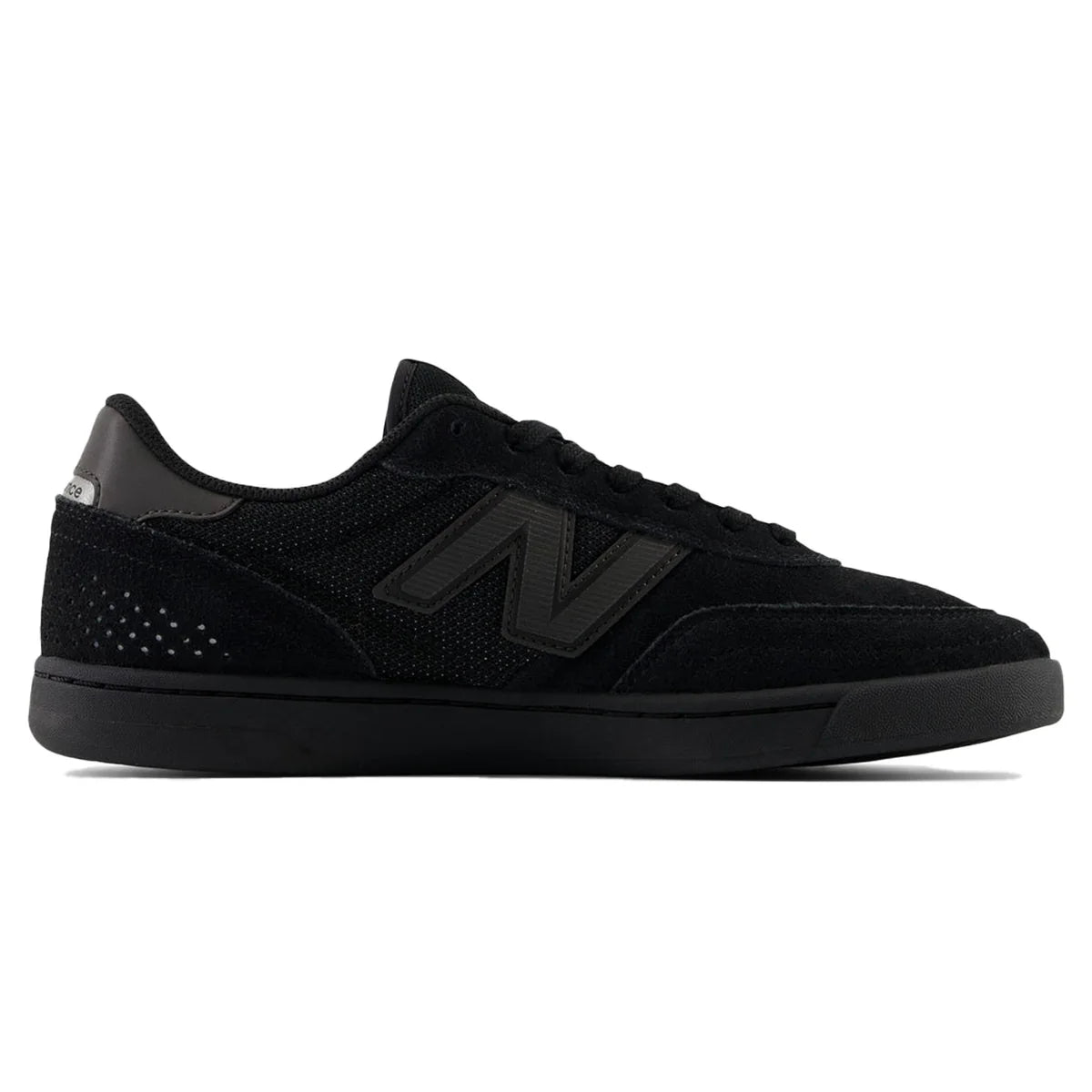 Black sneaker with green accents on a white background