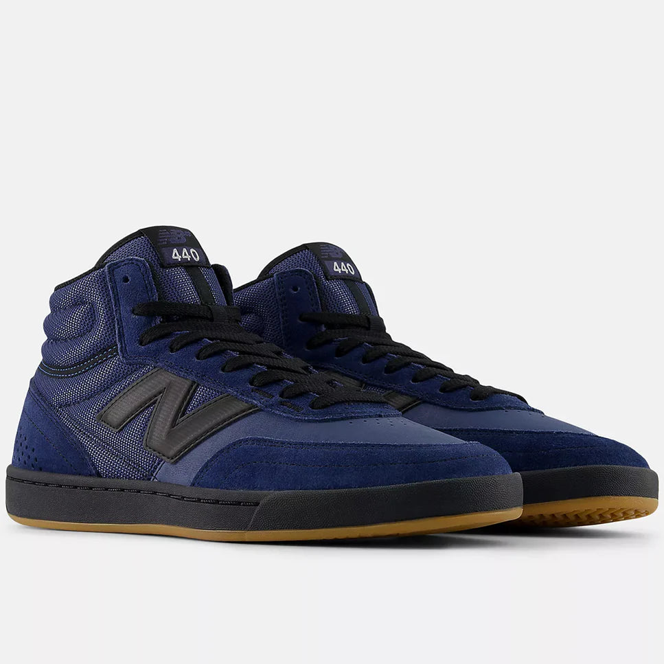 Pair of blue high-top sneakers with black accents on a white background