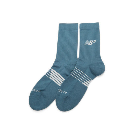 Pair of blue socks with white stripes and branding on a white background