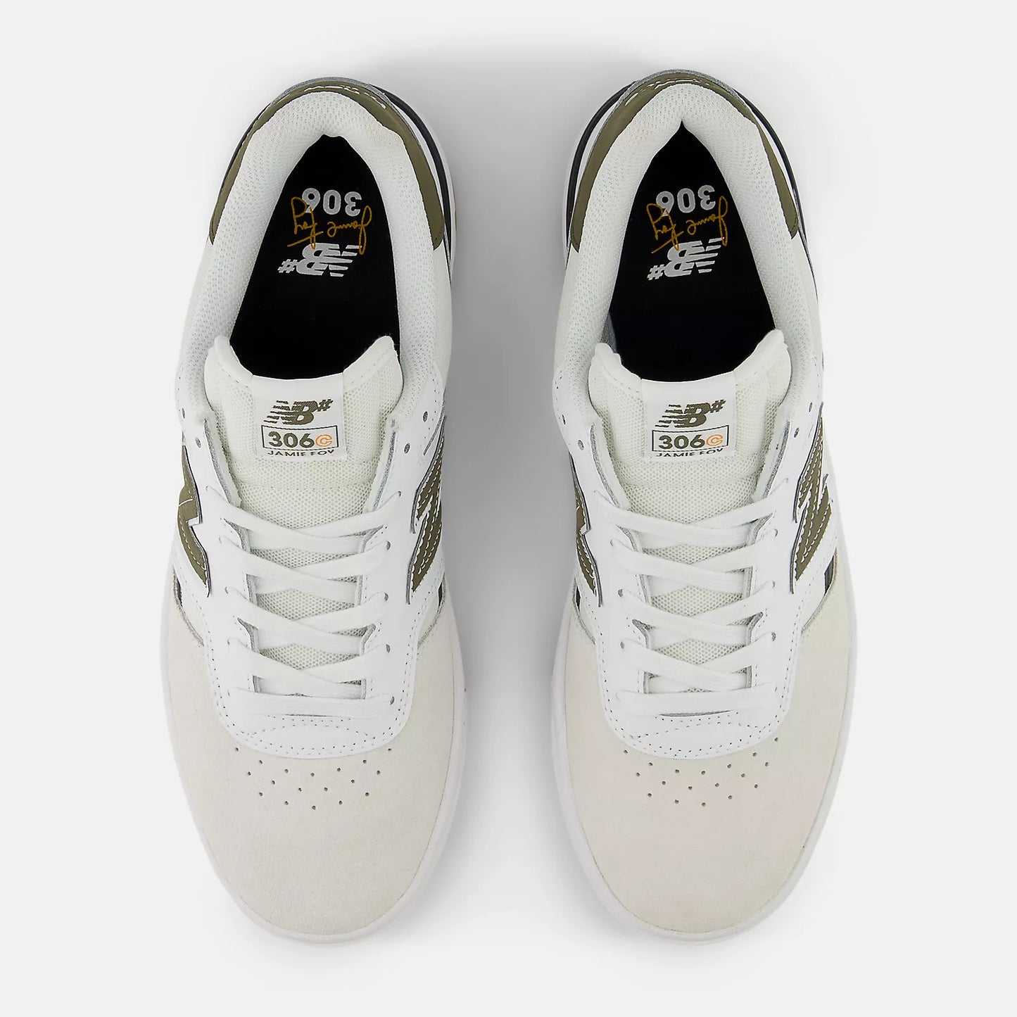 Pair of white sneakers with green accents on a light gray background