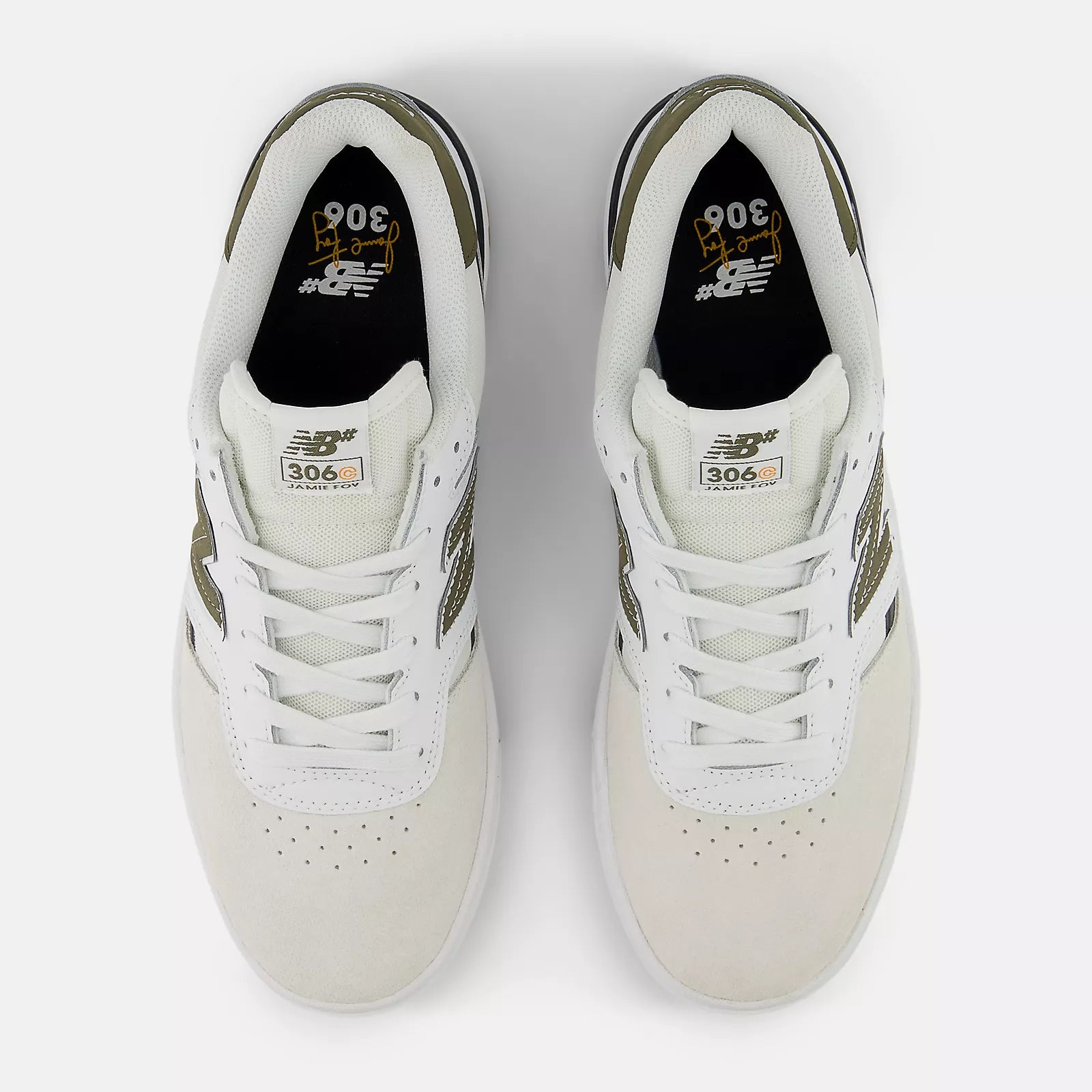 Pair of white sneakers with green accents on a light gray background