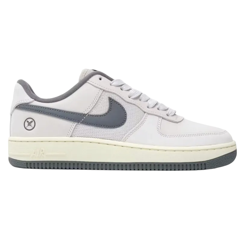 Nike SB Air Force 1 Low sneaker in Yuto Horigome White Iron Grey, featuring a white leather upper, grey Swoosh and heel tab, and a cream midsole with a dark grey outsole.