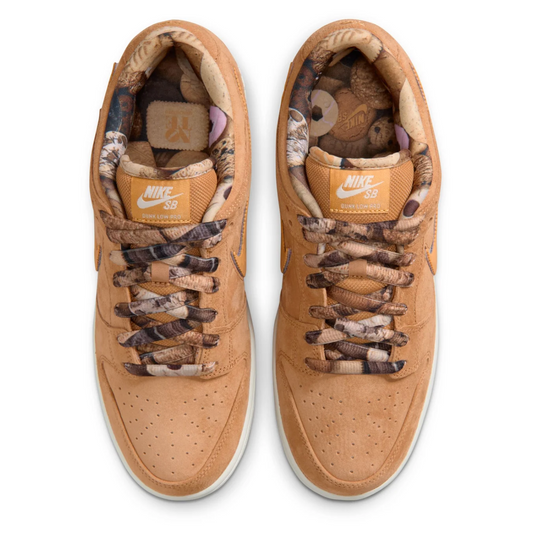 Pair of tan sneakers with camouflage accents on a white background