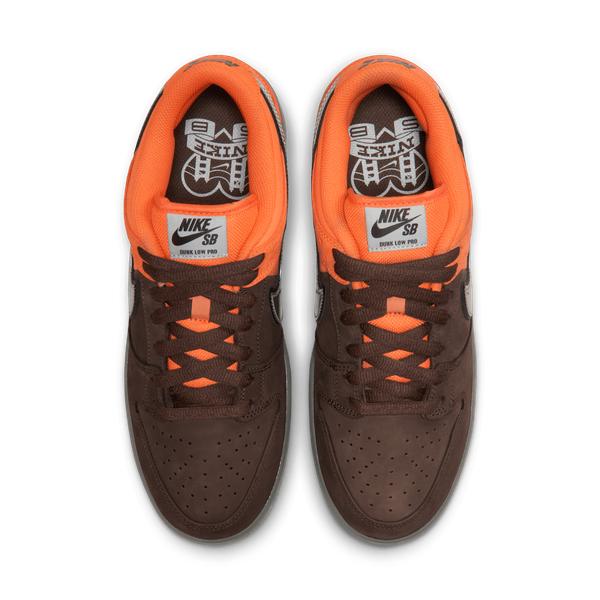 Pair of brown and orange sneakers with Nike SB logo on a white background