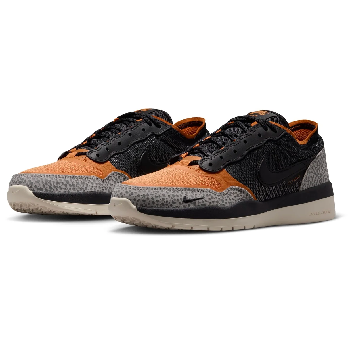 A pair of Nike Air Max 90 sneakers in black and orange with a speckled gray suede toe box, shown on a clean white background.