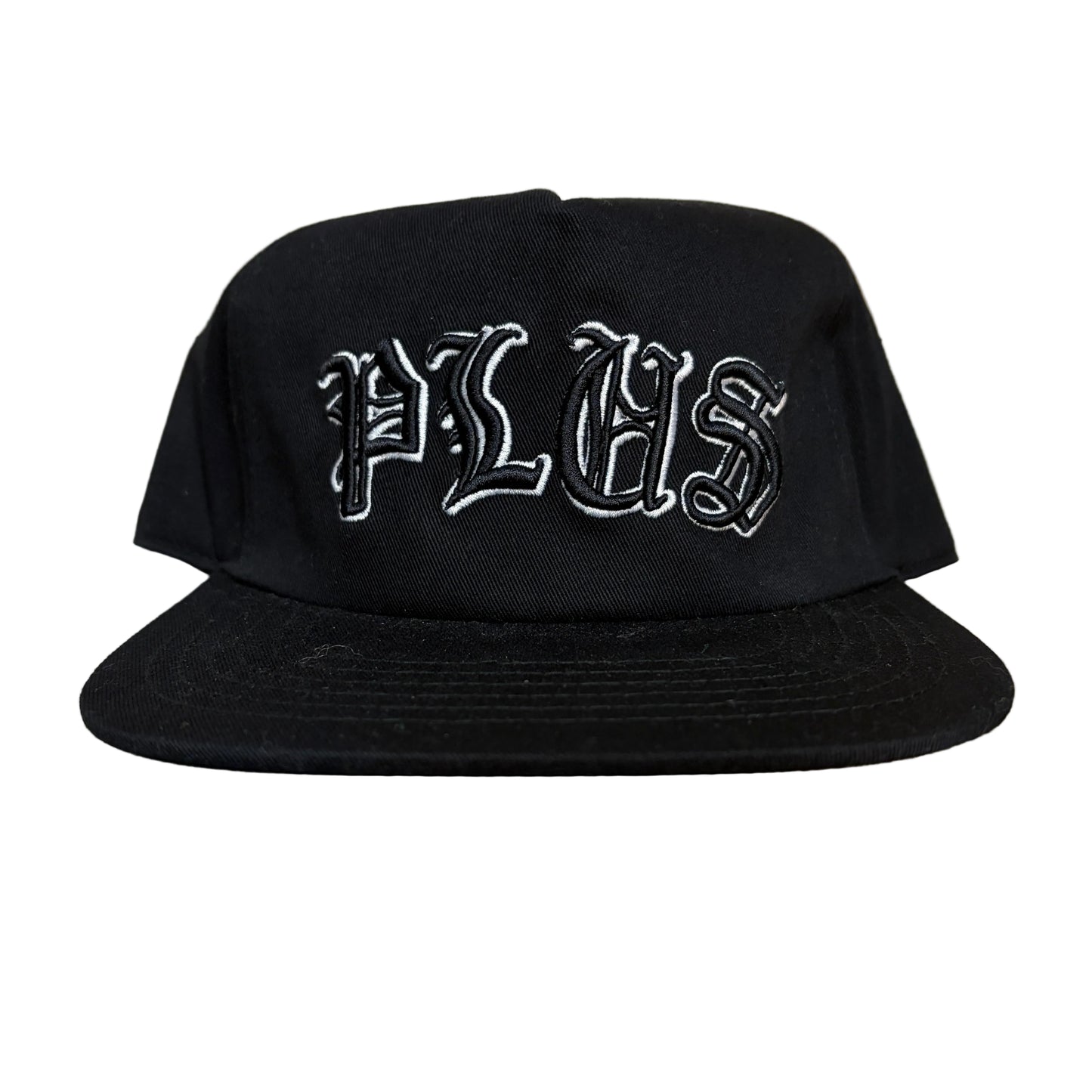 Black cap with white text on a wooden surface