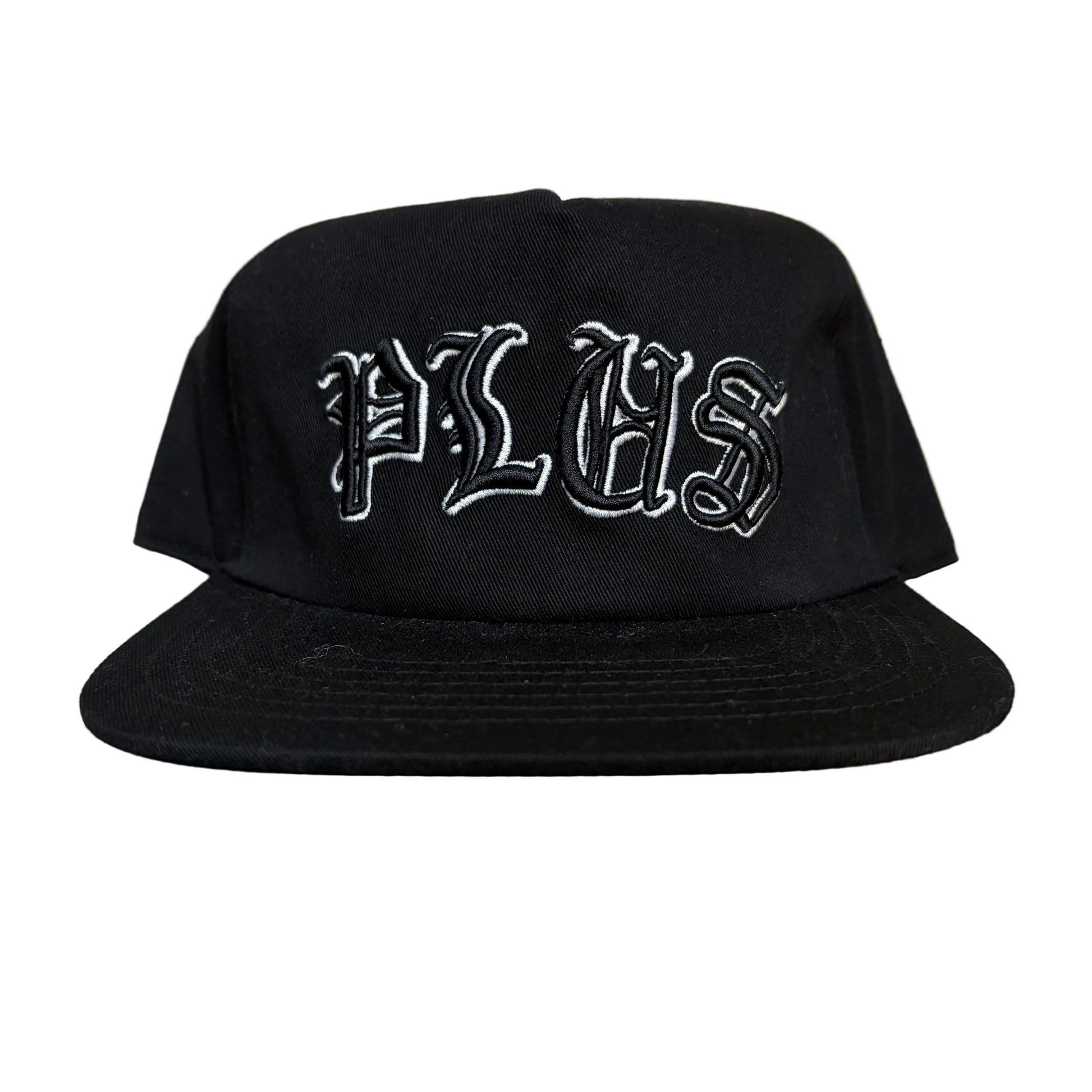 Black cap with white text on a wooden surface