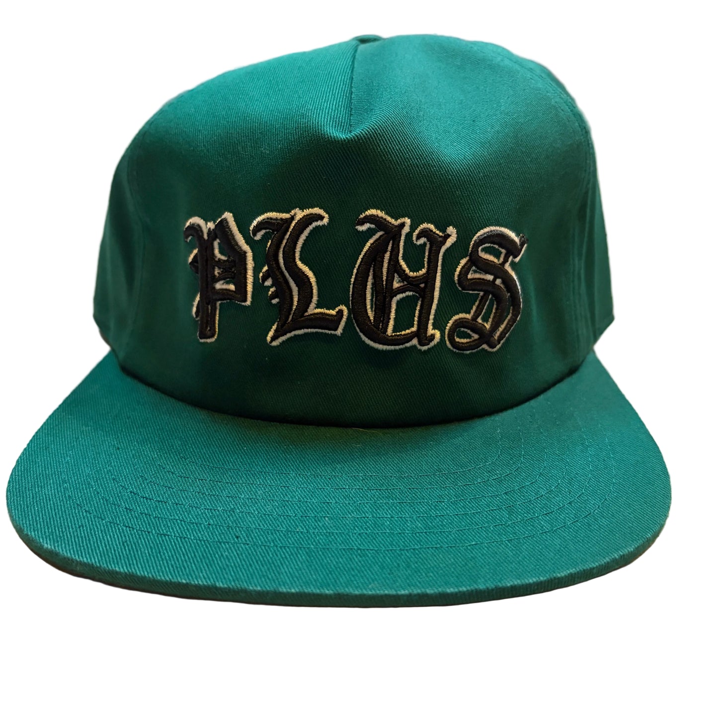 Green cap with 'PLHS' embroidery on a wooden surface