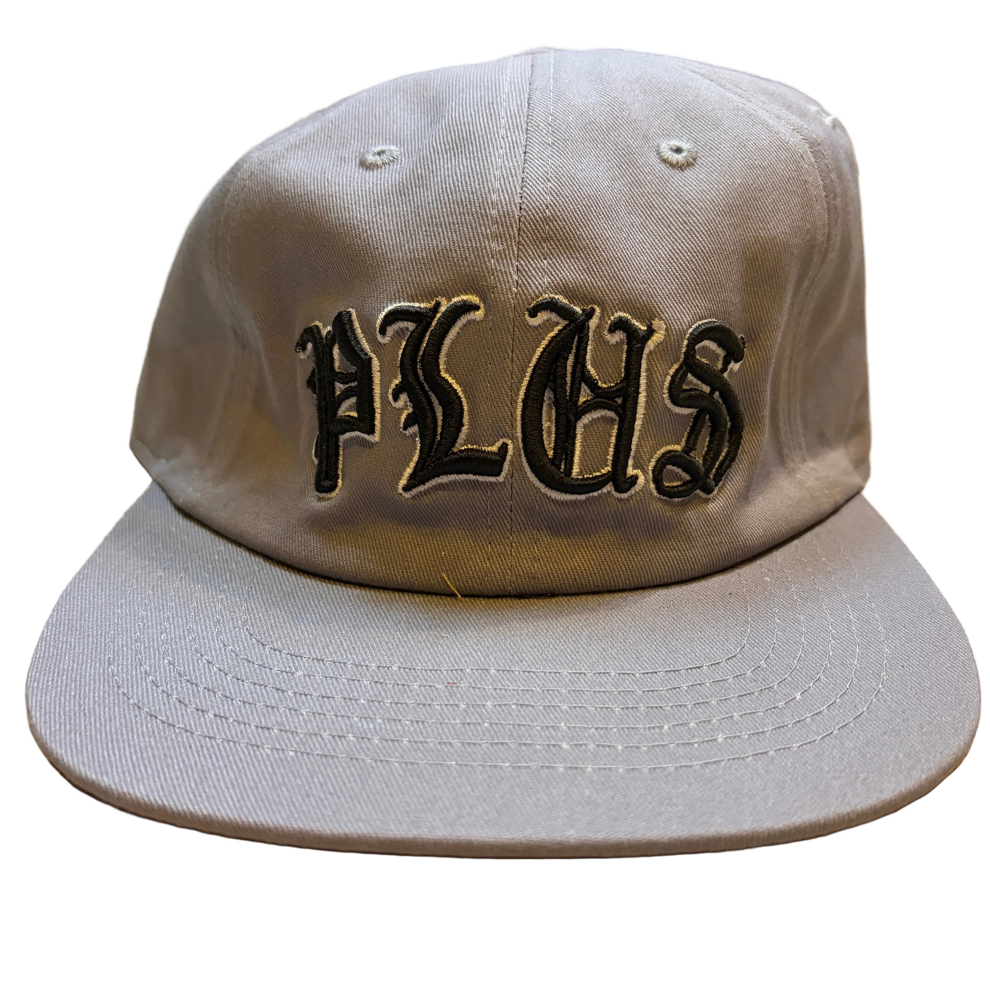Gray cap with 'PLHS' embroidery on a wooden surface