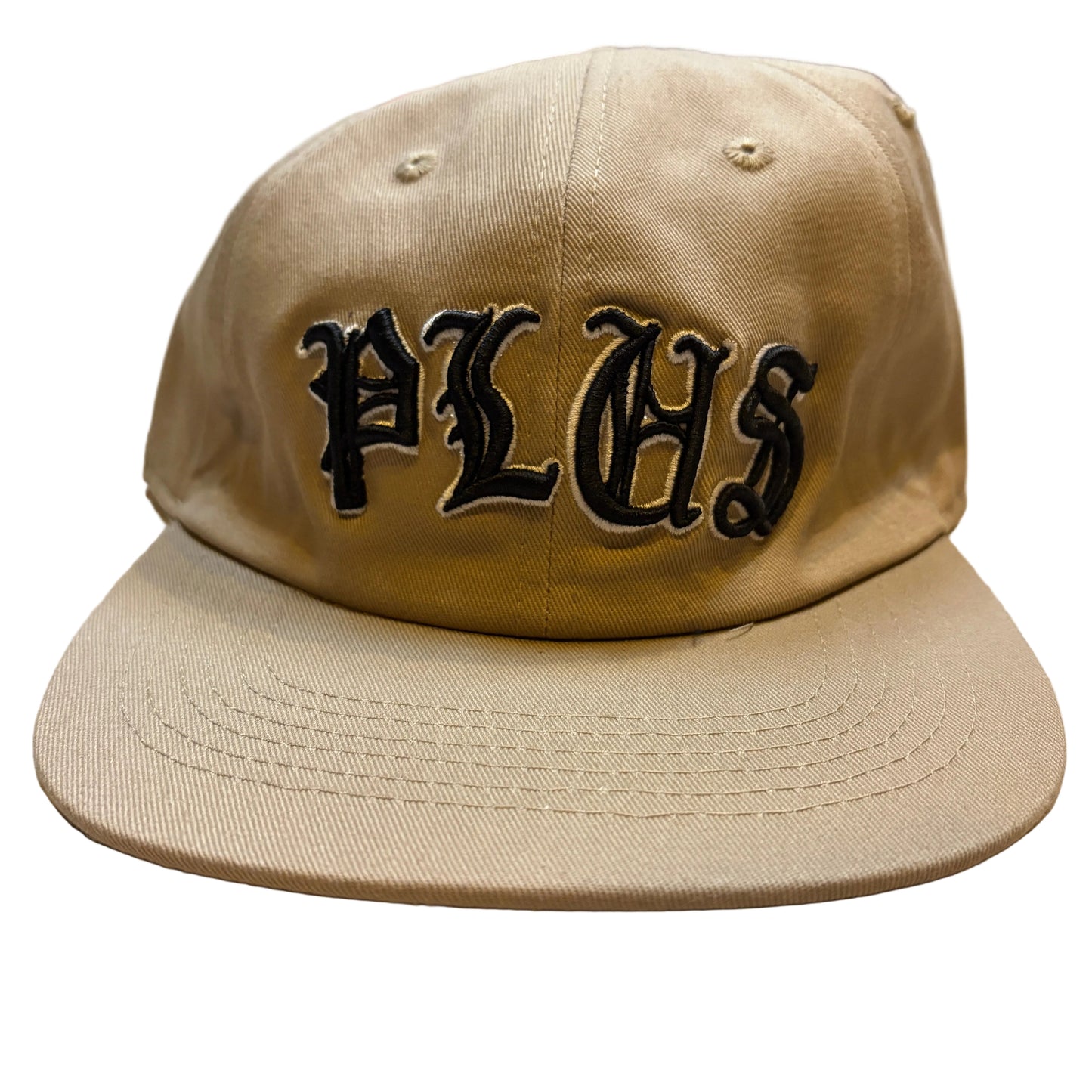 Beige cap with 'PLHS' logo on a wooden surface
