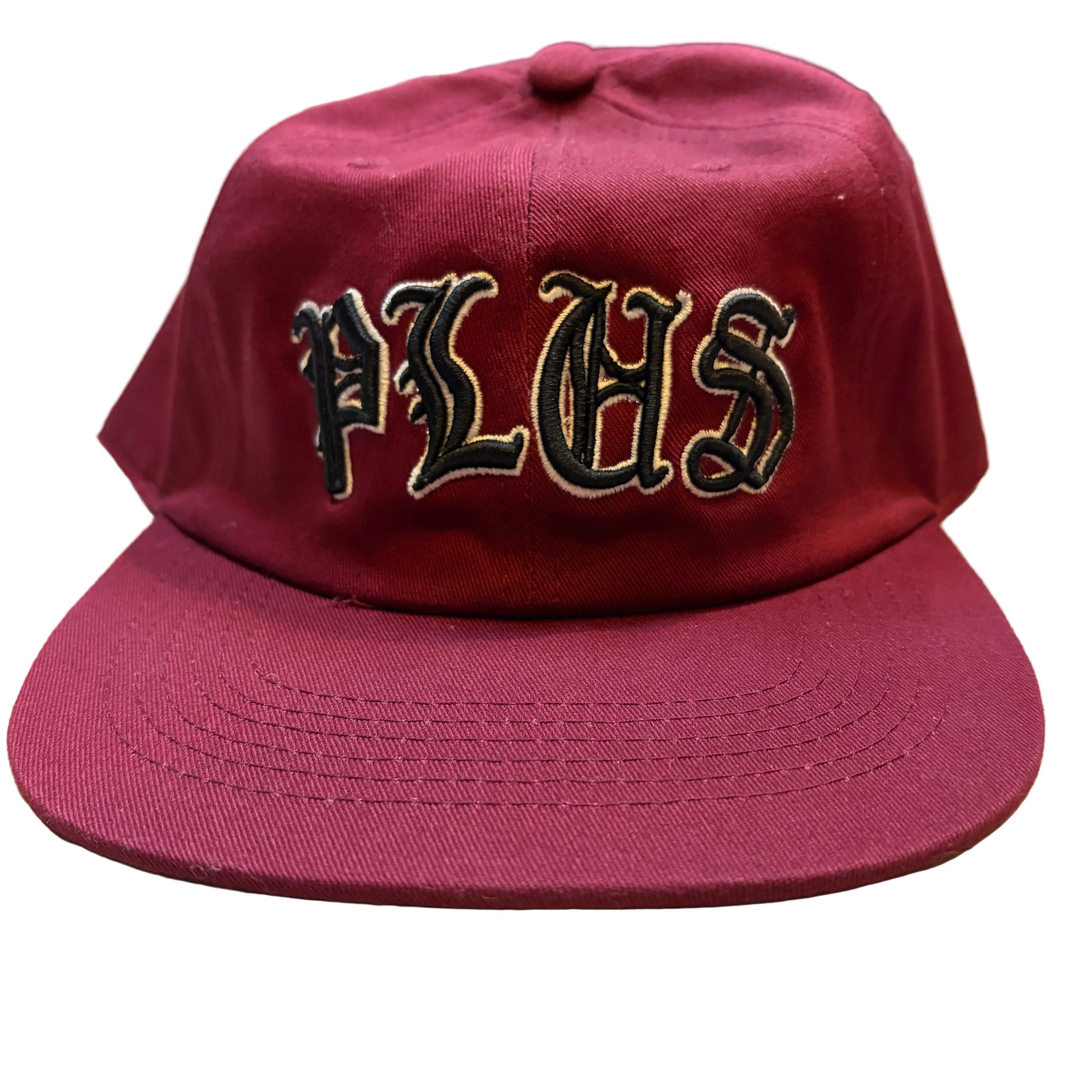 Maroon cap with 'PLHS' text on a wooden surface
